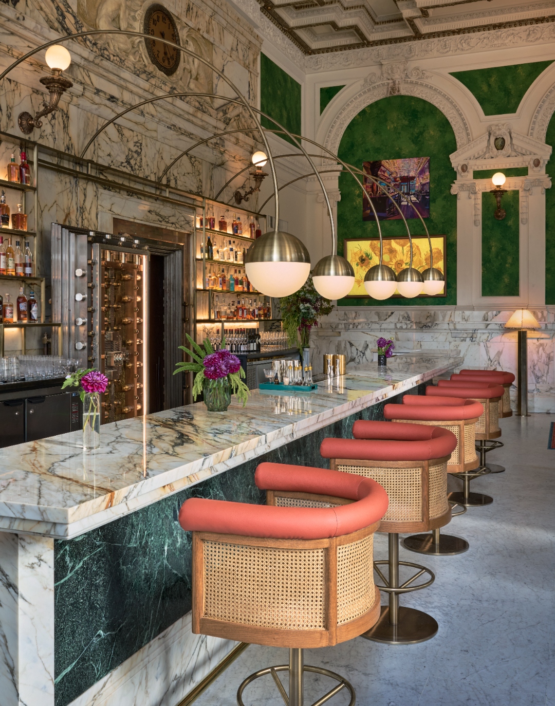 Marble bar and coral stools inside The Bank Café